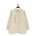 Beige shirt with floral design named Gwen Top from Maima on a white background