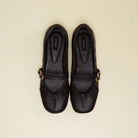 A pair of brown leather Mary Jane flatshoes with gold-tone buckle straps, shown from a top-down view on a light beige background. The brand name 'Cekhas' is visible on the insole of each shoe.