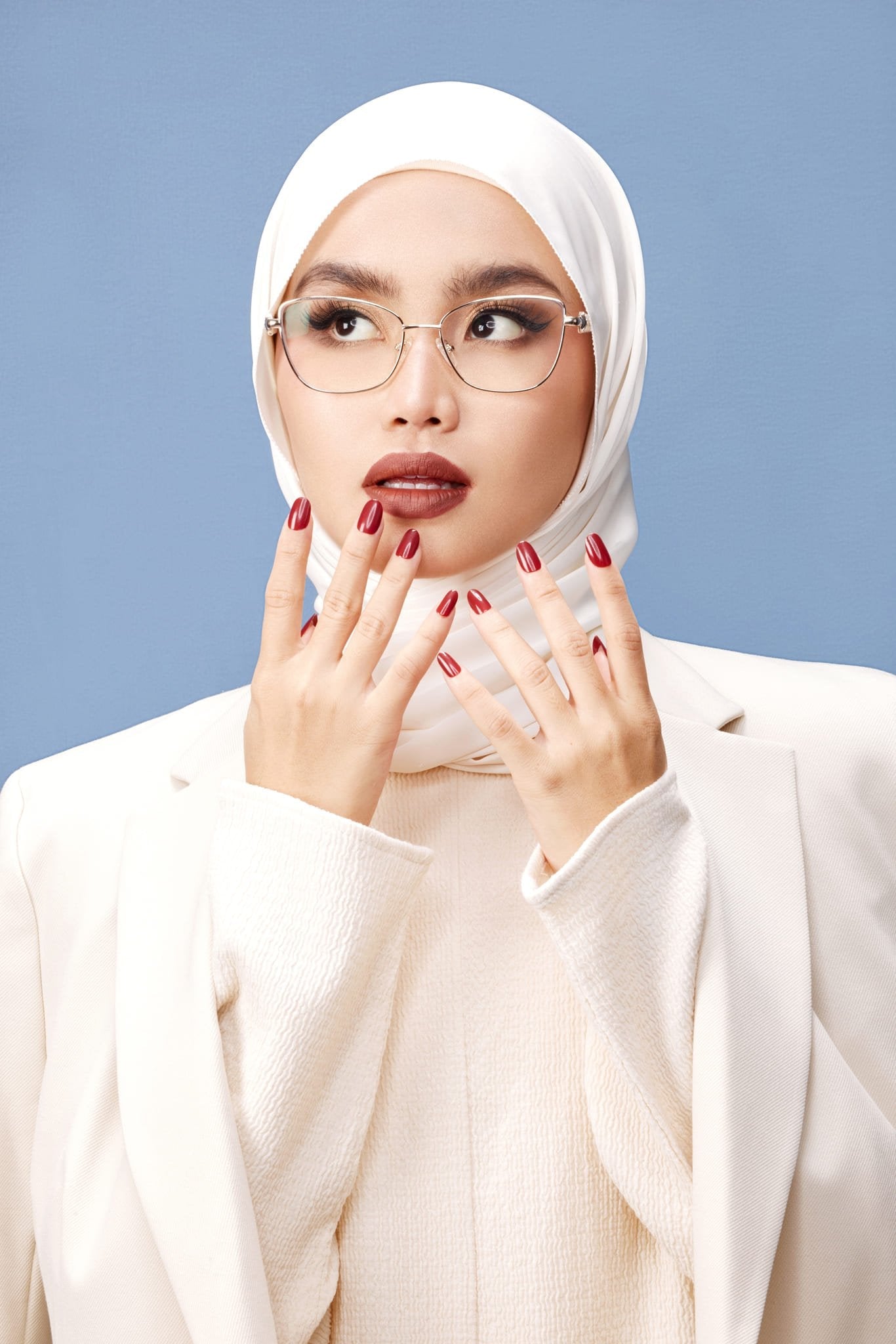 A person wearing a white marble full-frame eyeglass from HSF Eyewear with round lenses and a white headscarf.