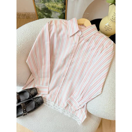 Pink and white striped shirt by Haidee Orlin on a chair with a blurred background