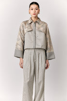 Person wearing a patterned outer by Studio Tui on a white background