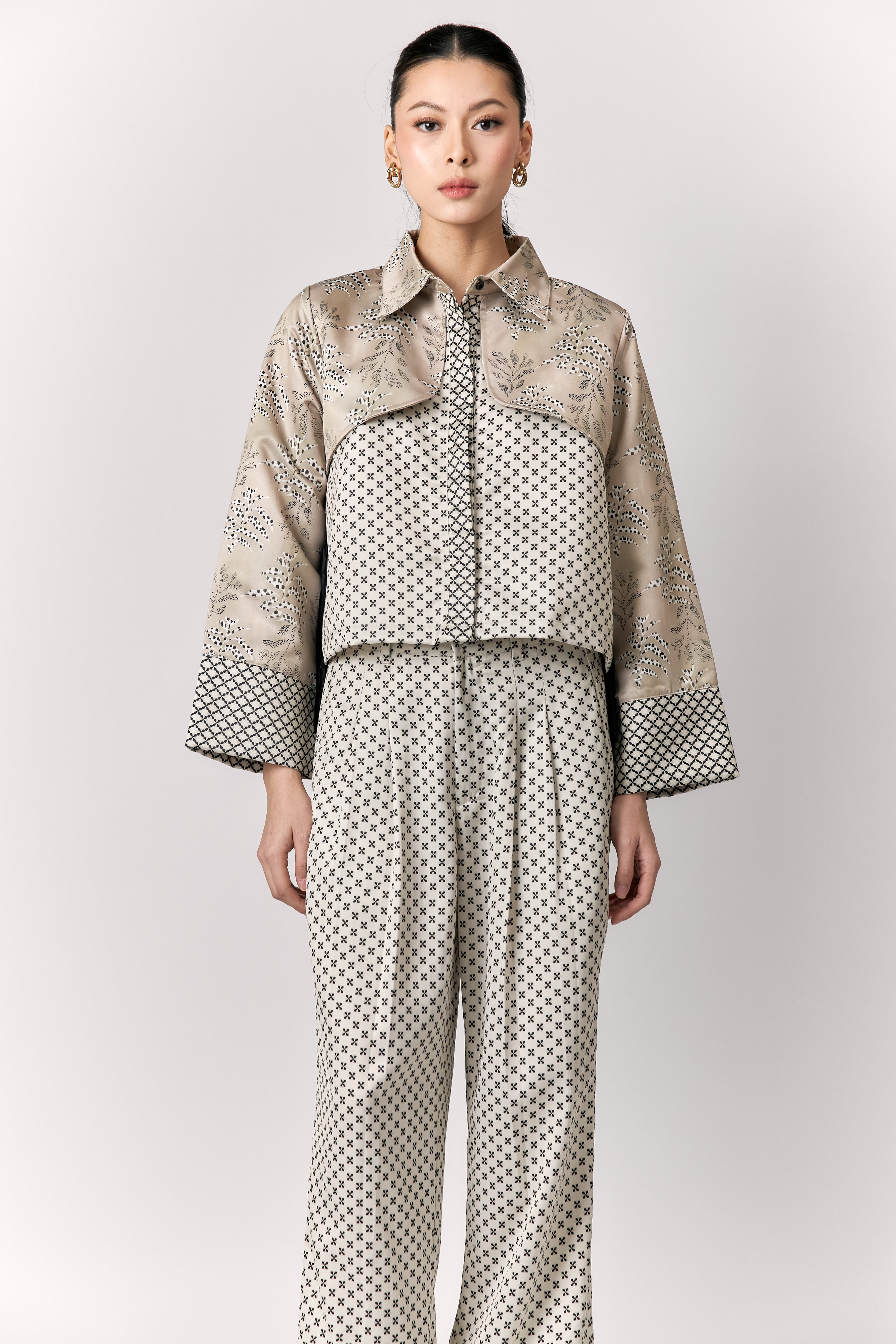 Person wearing a patterned outer by Studio Tui on a white background