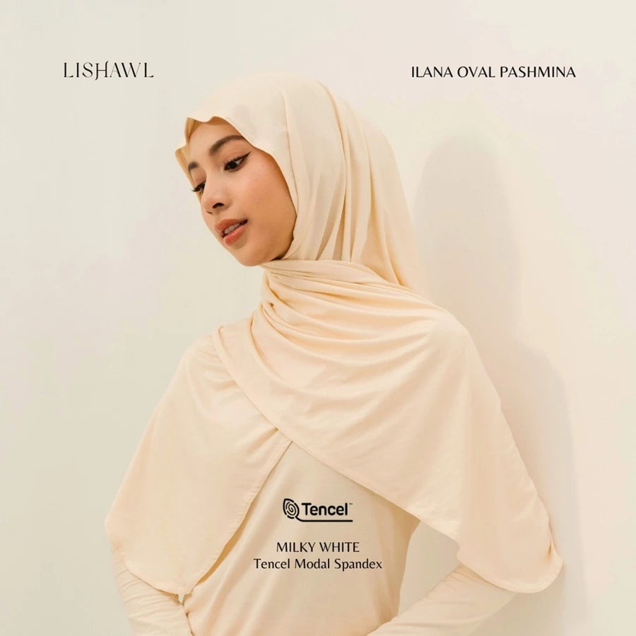 Woman wearing a cream Lishawl Ilana Oval Pashmina by BWBYAZ on a light background