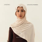 Woman wearing a light brown Lishawl Ilana Oval Pashmina by BWBYAZ on a plain background