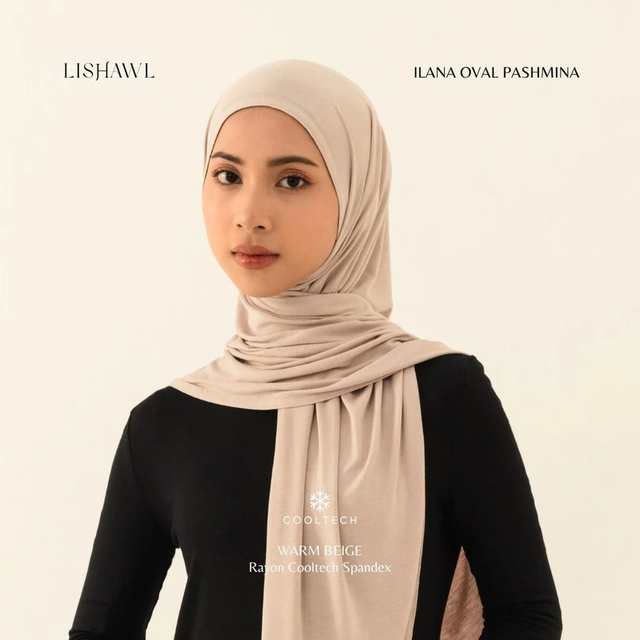 Woman wearing a beige Lishawl Ilana Oval Pashmina by BWBYAZ on a plain background