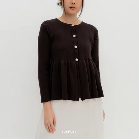 A person wearing a dark brown irish knit peplum cardigan with long sleeves and a round neckline from BWBYAZ.