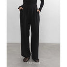Black wide-leg pants worn by a person on a plain background with 'kasyalia' branding.