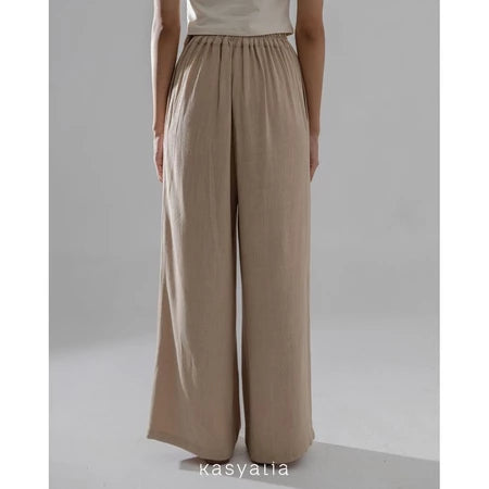 Light brown wide-leg pants worn by a person on a plain background with 'kasyalia' branding.