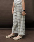 Person wearing plaid pants by Mistyvori on a brown background
