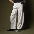 Person wearing white barrel pants and black shoes on a dark background with 'BWBYAZ' branding.