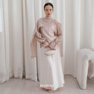 A model wearing a ivory shawl top with long sleeves and a separate shawl from BWBYAZ, standing in a room with a chair and a plain background.