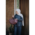 Woman wearing a dark denim shirt by Renaette and denim pants