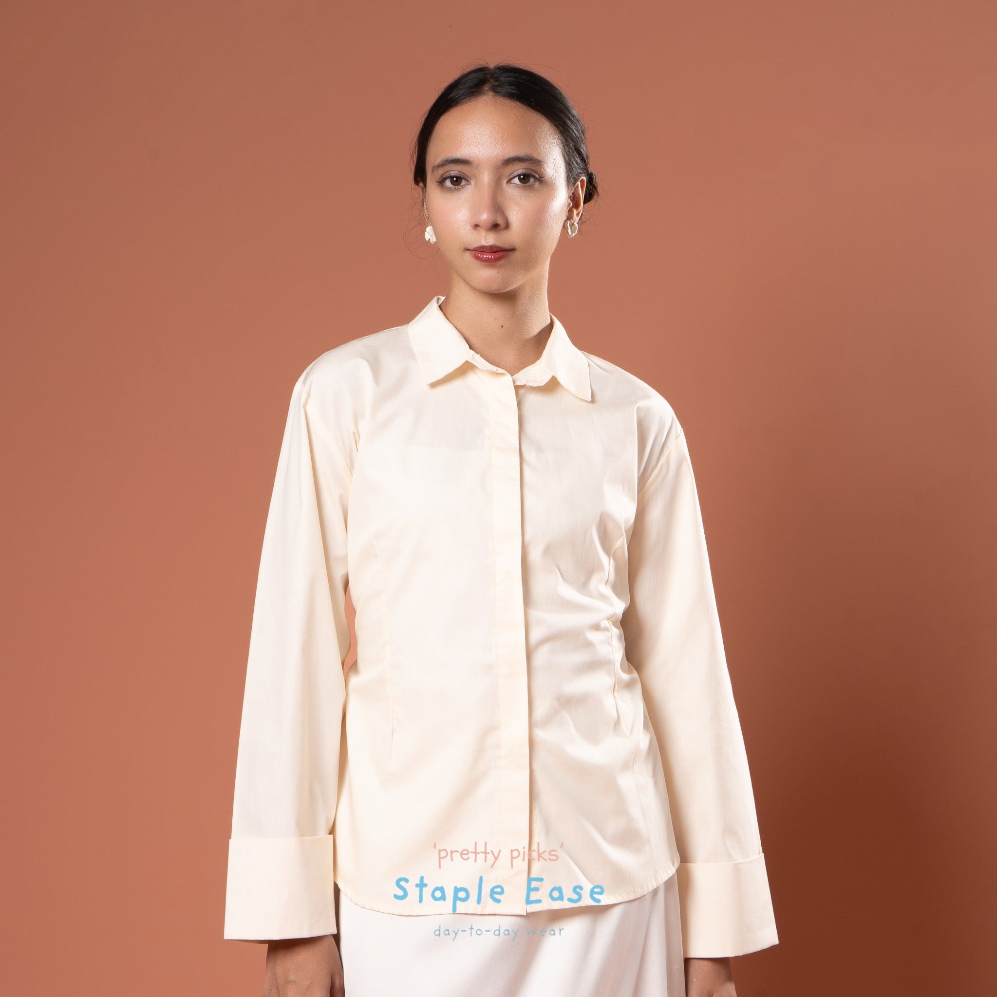 Woman wearing a beige shirt by BWBYAZ against a brown background