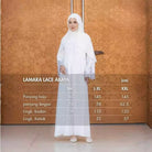 Woman wearing a white lace abaya with size chart against an orange patterned wall.