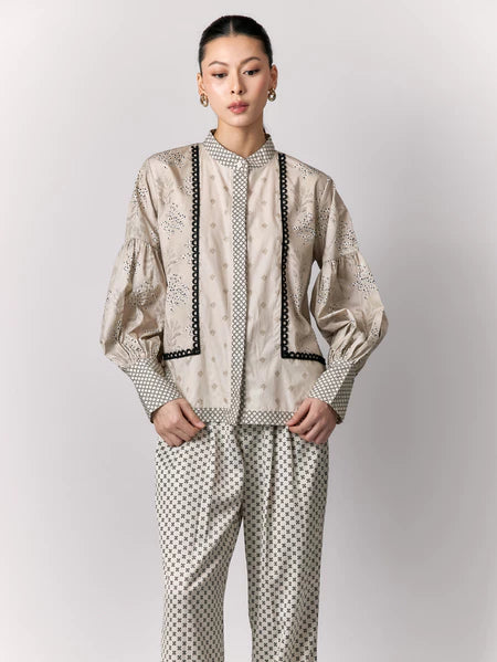 Person wearing a patterned shirt by Studio Tui on a plain background