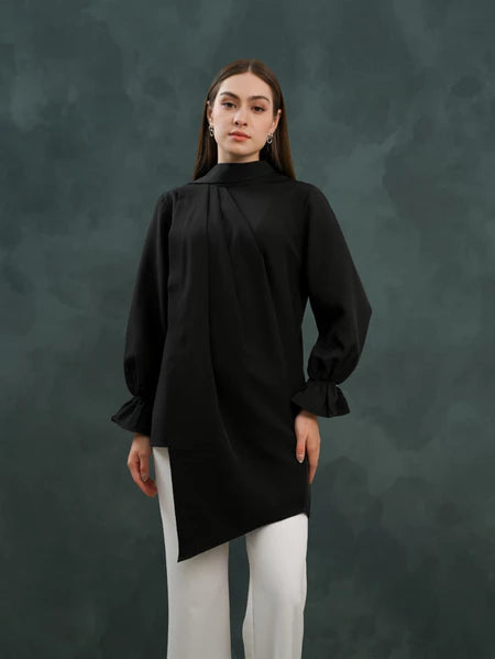 Person wearing a black blouse by Kasa Heritage with a high collar against a dark background