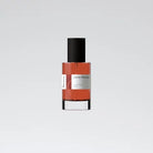 A bottle of Boura Living Montage perfume with a clear liquid visible inside, having a black cap and a white label.