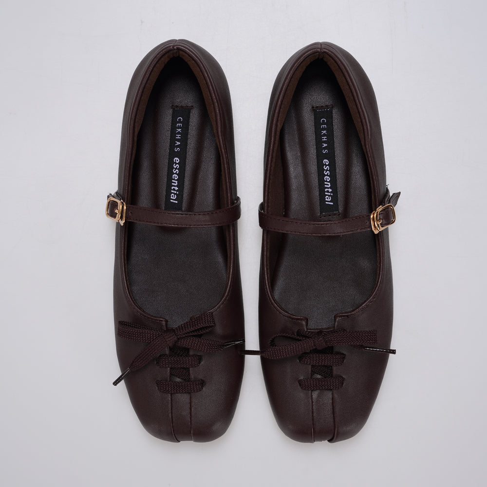 A pair of brown Mary Jane ballet flatshoes by Cekhas with matching ribbon bows and small gold-tone buckle details, displayed on a light gray background.