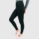 Person wearing black leggings by HIA on a light gray background