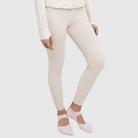 Person wearing cream leggings by HIA and pink socks on a white background