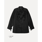 Black top by Maima with bow details on a light gray background