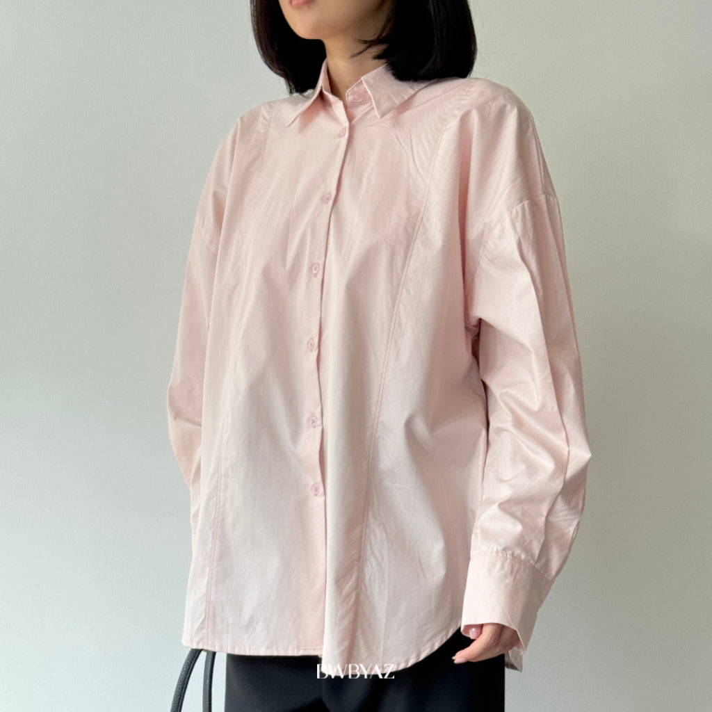 Person wearing a light pink shirt from BWBYAZ against a plain background