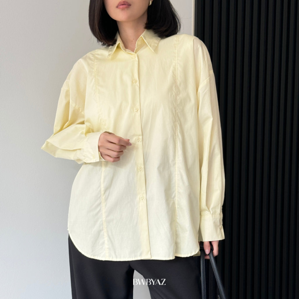 Person wearing a light yellow shirt from BWBYAZ against a plain background