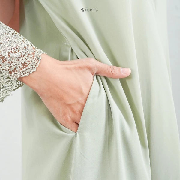 Light green abaya with lace-trimmed sleeve, TUBITA brand visible