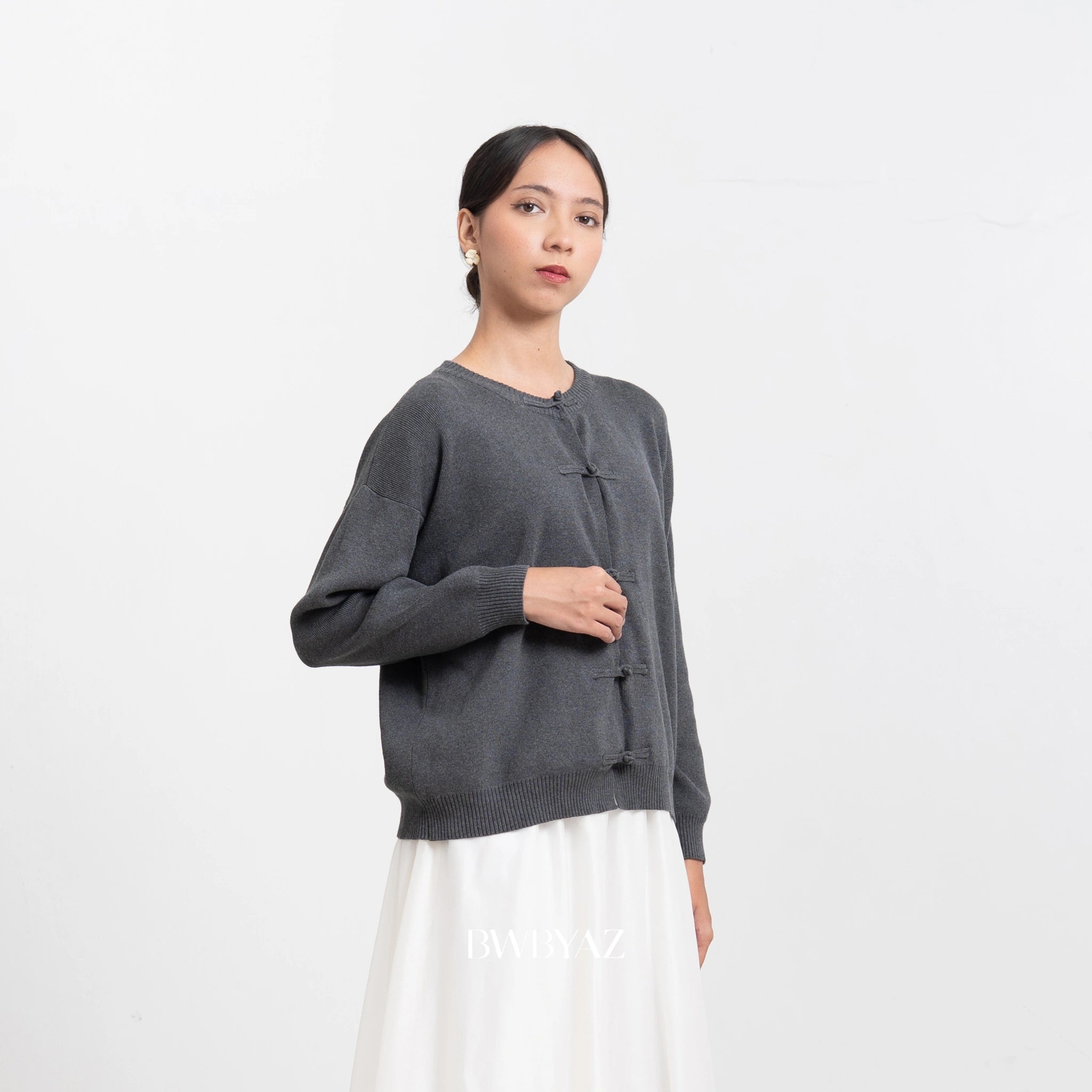 Woman wearing a gray cardigan by BWBYAZ on a white background