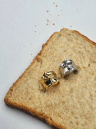 Gold and silver rings by Darje on a slice of bread