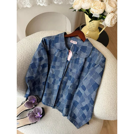 Blue checkered denim jacket from Haidee Orlin on a hanger with a blurred background