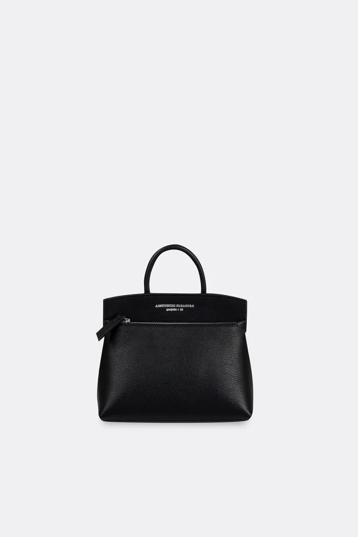 Black grain leather mini handbag by Aesthetic Pleasure on a light gray background