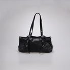 A black leather shoulder bag by Cekhas with silver-tone hardware, shown against a neutral light gray background.