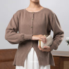 Person wearing a brown cardigan from BWBYAZ holding a clutch against a neutral background