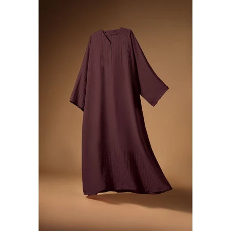 Burgundy Mecca Dhurma Abaya by Nehhat Modest on a brown background