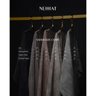 Nehhat Abaya on hangers with a size chart below against a black background