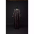 Long dark outer robe by Nehhat Modest on a hanger against a black background