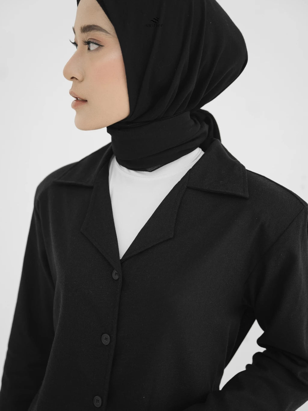 Person wearing a black hijab and black blazer by Swifter on a white background