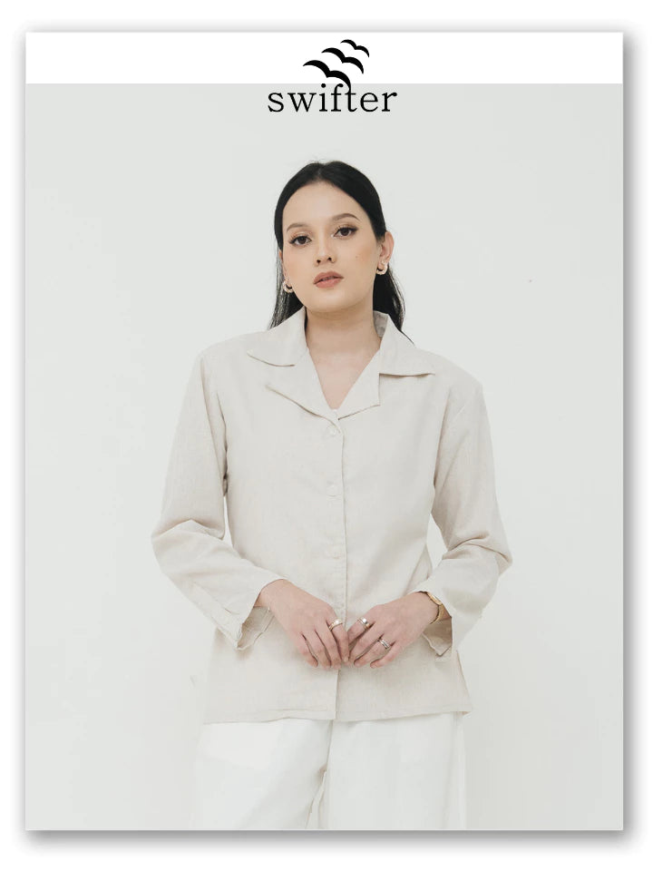 Woman wearing a light brown blazer by Swifter.