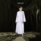 Woman wearing a light pink traditional outfit with 'BWBYAZ' branding against a dark curtain background.