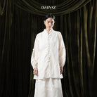 Woman wearing a cream tunic with lace details against a dark curtain backdrop with 'BWBYAZ' branding.

Seorang wanita mengenakan tunik krem dengan detail renda di depan latar belakang tirai gelap dengan merek ‘BWBYAZ’.