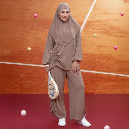 Woman in light brown hijab activewear set by Lozy Hijab a padel court