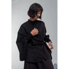 Person wearing a black shirt by Yestoday against a plain background