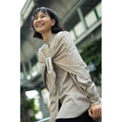 Woman wearing a beige shirt by Yestoday with a blurred background