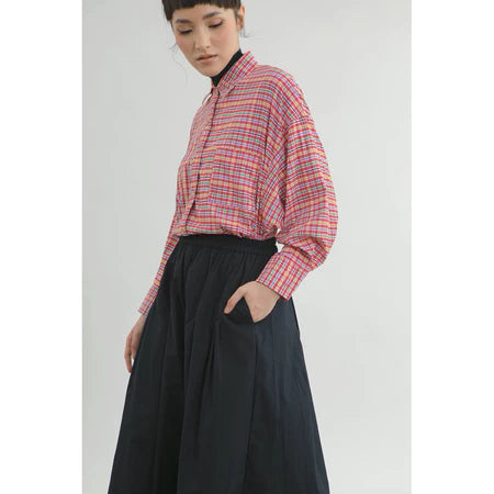 Person wearing a plaid red shirt by Yestoday and black pants on a white background