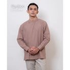 Man wearing a brown long-sleeve koko shirt by Atala Scarves against a white background.