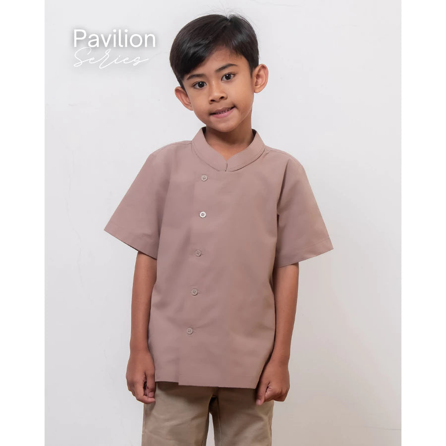 Child wearing a brown koko shirt by Atala Scarves and pants on a white background.