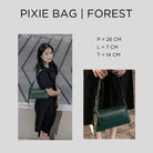 Green Pixie Bag by Prior held by a person with product dimensions displayed.
