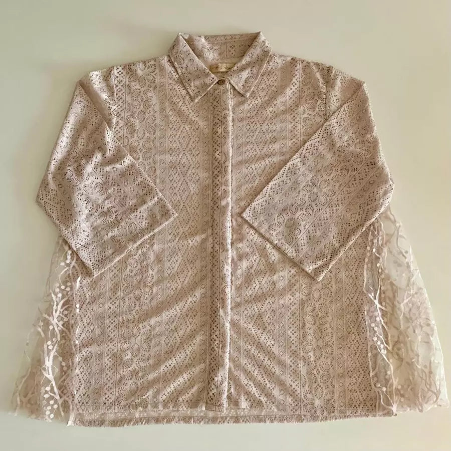 Nude-colored lace blouse by Holy Peony on a light beige background