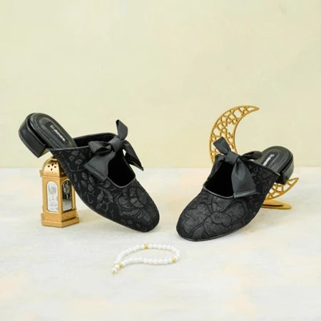 Black lace shoes with bows by Dianable on a decorative background